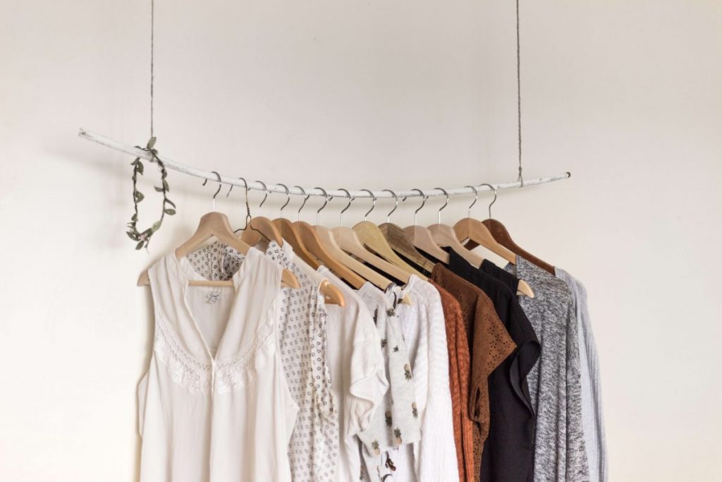 A capsule wardrobe of simple, neutral tones can serve you well as offices re-open. (Photo credit: Priscilla Du Preez on Unsplash)