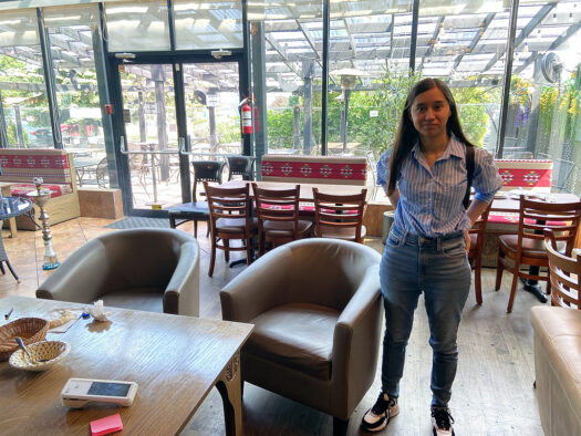 Marwa Dashty at the restaurant in Toronto where she now works. She and her family fled Afghanistan in 2021, but her father stayed behind to join the resistance. (Credit: Colleen DeBaise)