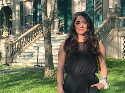 Rodaba Noori, now a student at Bard College, stands in front of Montgomery Place, a mansion overlooking the Hudson River. (Credit: Kate Brennan)